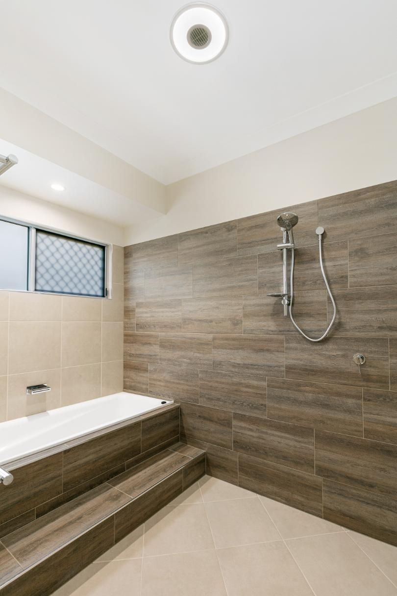 A Bathroom With a Bathtub and a Shower — Ashlee Jones Homes in Gordonvale, QLD