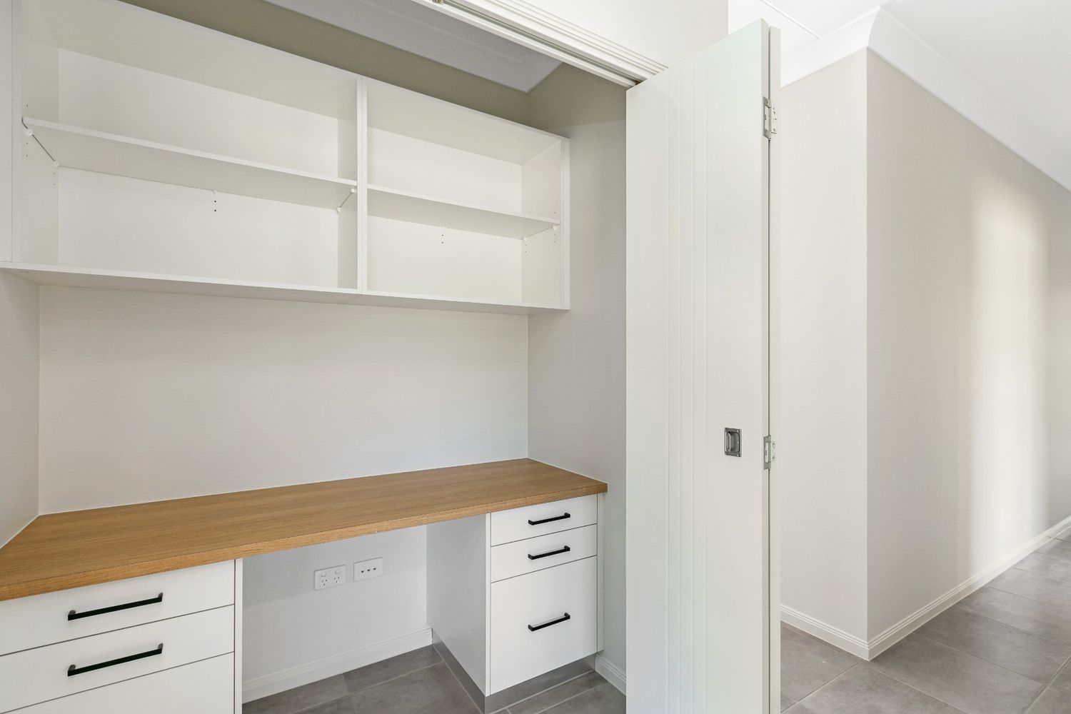 A Room With a Desk, Drawers, Shelves and a Door — Ashlee Jones Homes in Gordonvale, QLD