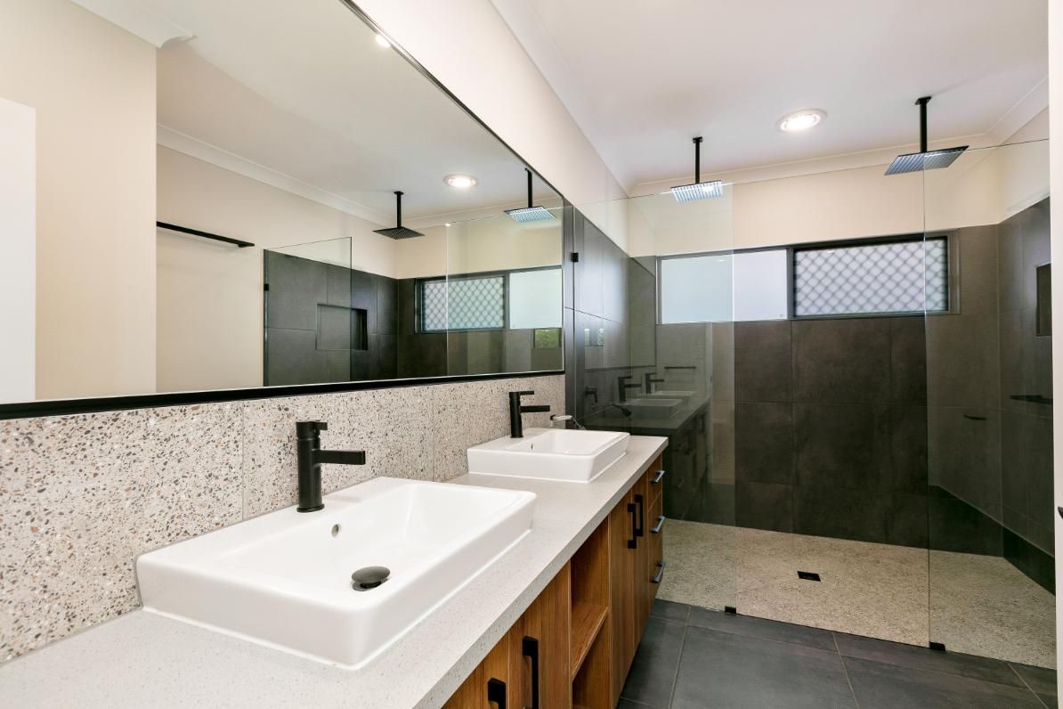 A Bathroom With Two Sinks and a Walk in Shower — Ashlee Jones Homes in Gordonvale, QLD