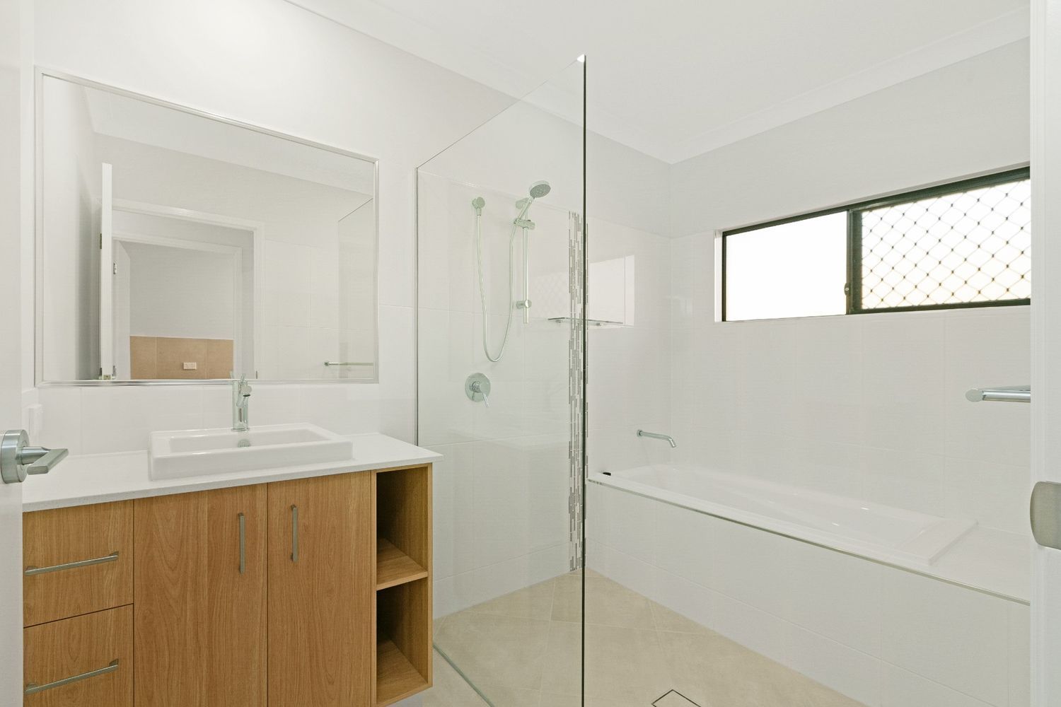 A Bathroom With a Sink, Tub, Shower and Mirror — Ashlee Jones Homes in Gordonvale, QLD