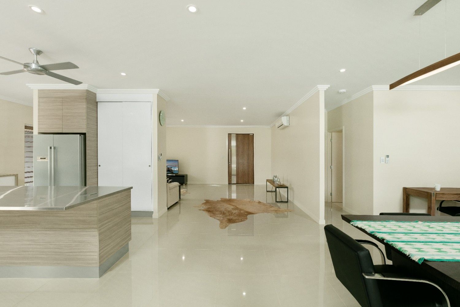 A Room With a Table and Chairs and a Ceiling Fan — Ashlee Jones Homes in Gordonvale, QLD