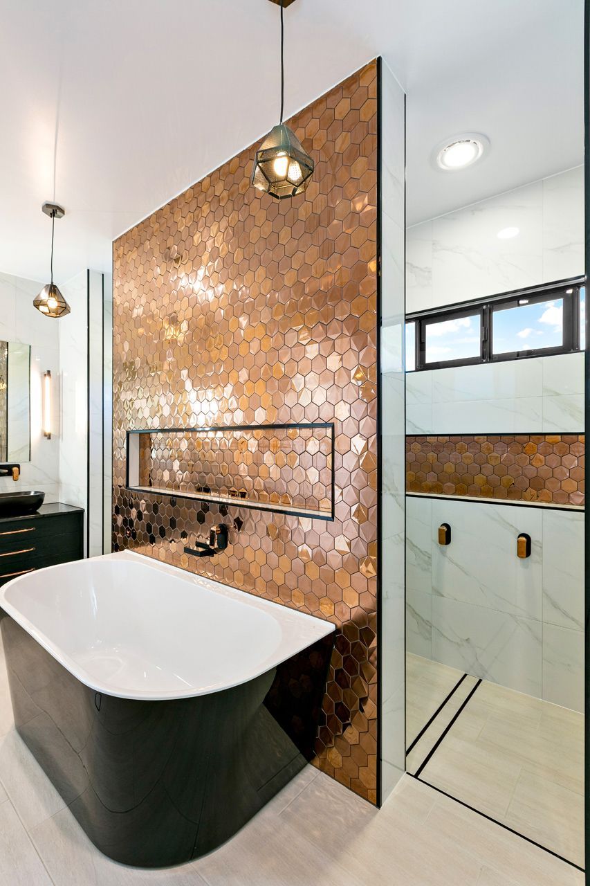 A Modern Bathroom With a Black Freestanding Tub — Ashlee Jones Homes in Gordonvale, QLD