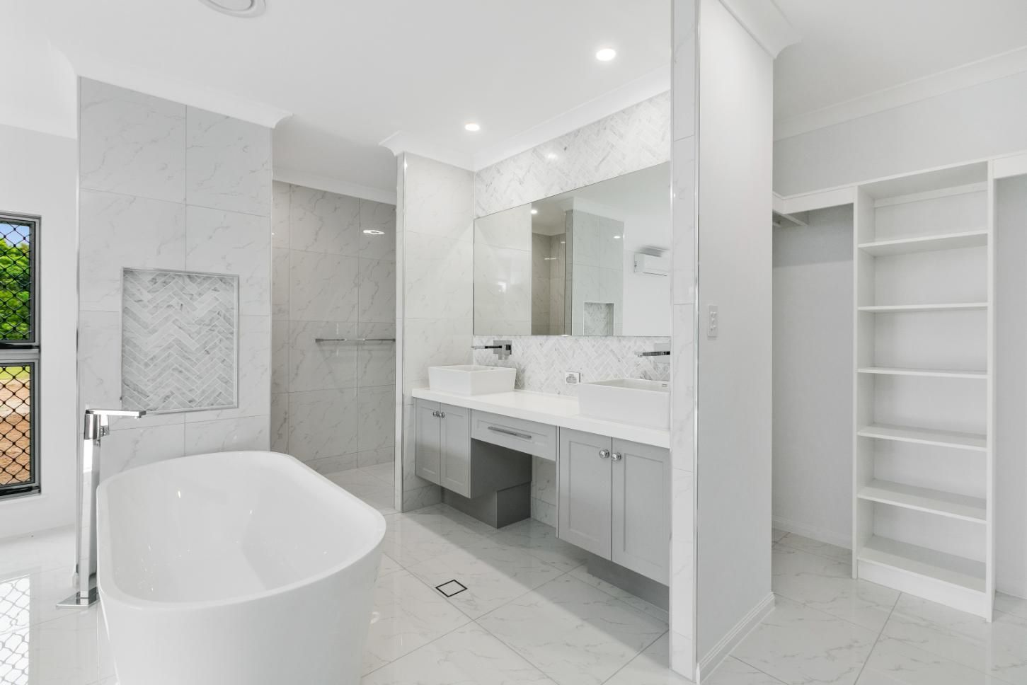 A Bathroom With a Bathtub, Sinks, Mirrors and Shelves — Ashlee Jones Homes in Gordonvale, QLD