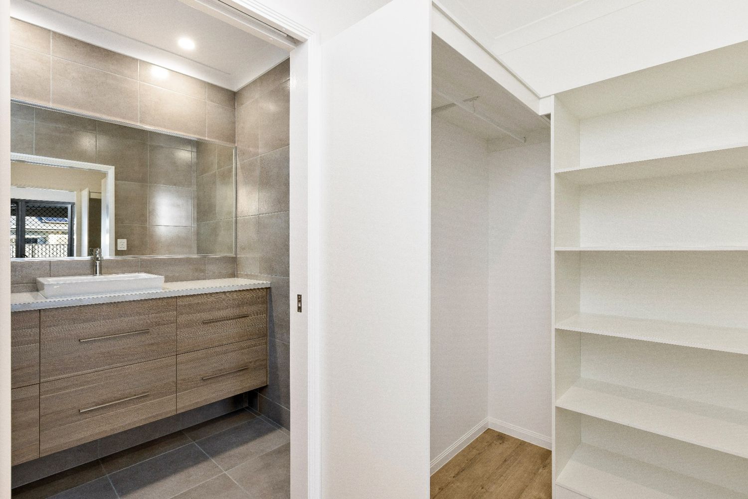 A Bathroom With a Sink and a Walk in Closet — Ashlee Jones Homes in Gordonvale, QLD