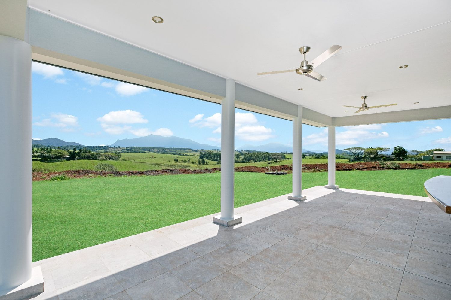 An Empty Porch With a View of a Grassy Field — Ashlee Jones Homes in Gordonvale, QLD