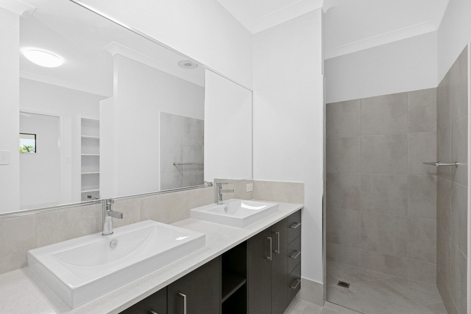 A Bathroom With Two Sinks and a Walk in Shower — Ashlee Jones Homes in Gordonvale, QLD