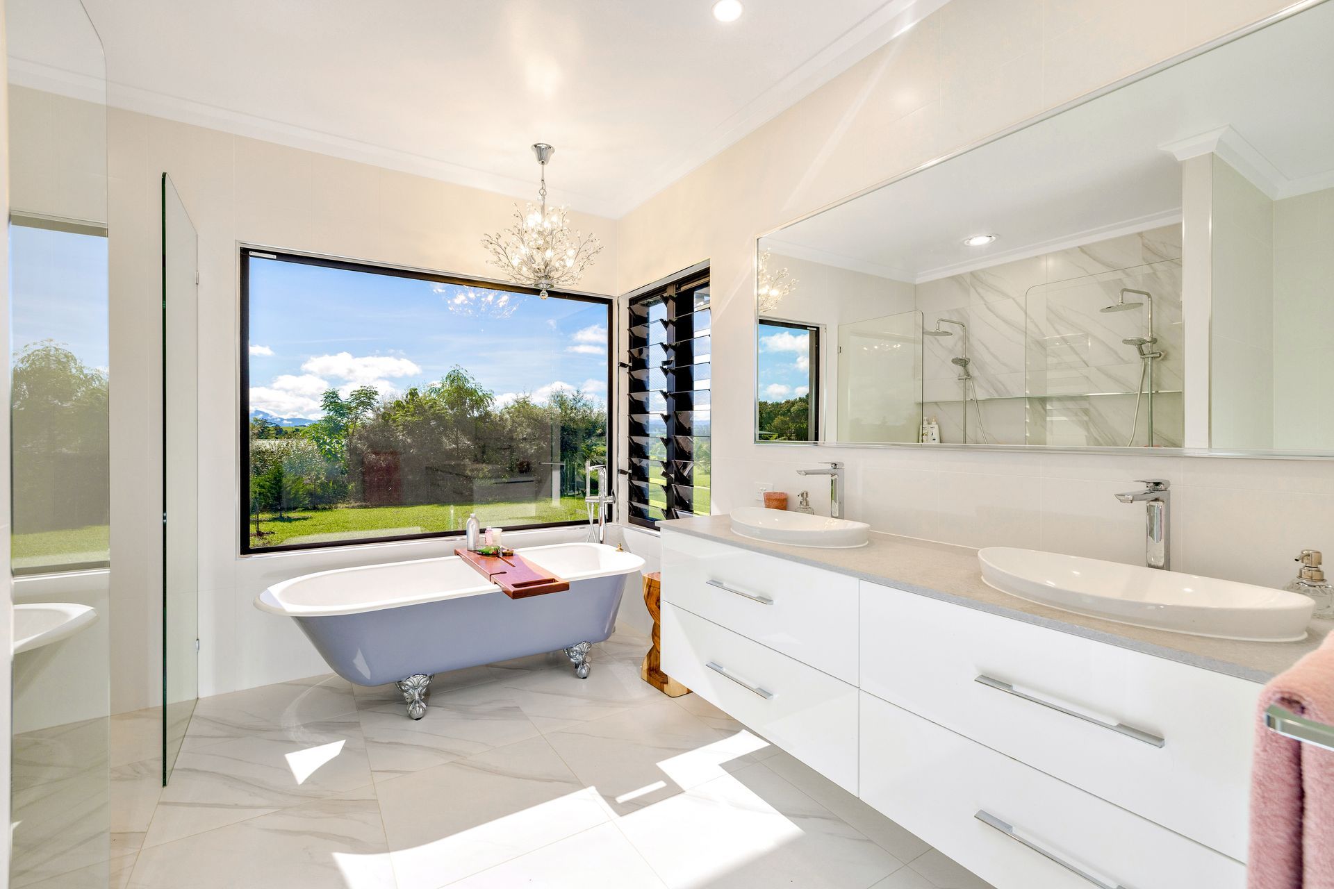 A Bathroom With Two Sinks And Two Mirrors — Ashlee Jones Homes in Gordonvale, QLD