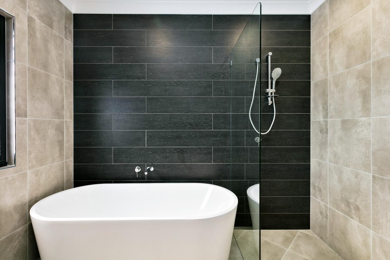 A Bathroom With a Bathtub and a Walk in Shower — Ashlee Jones Homes in Gordonvale, QLD
