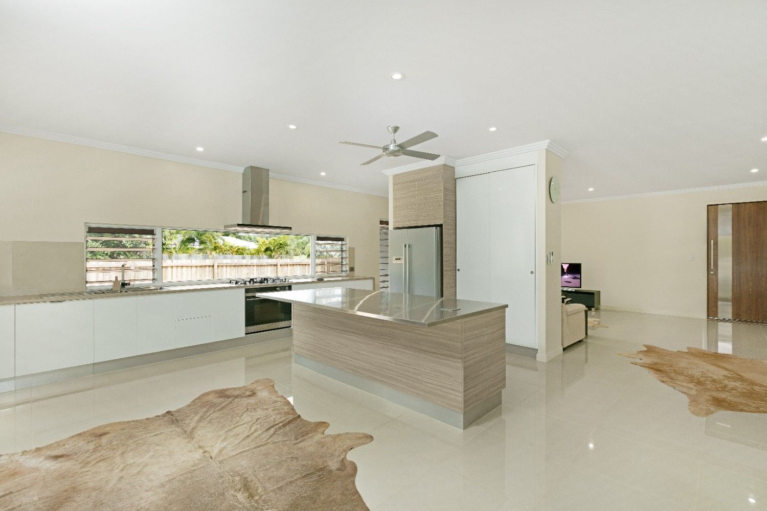 A Kitchen With a Rug on the Floor and a Ceiling Fan — Ashlee Jones Homes in Gordonvale, QLD