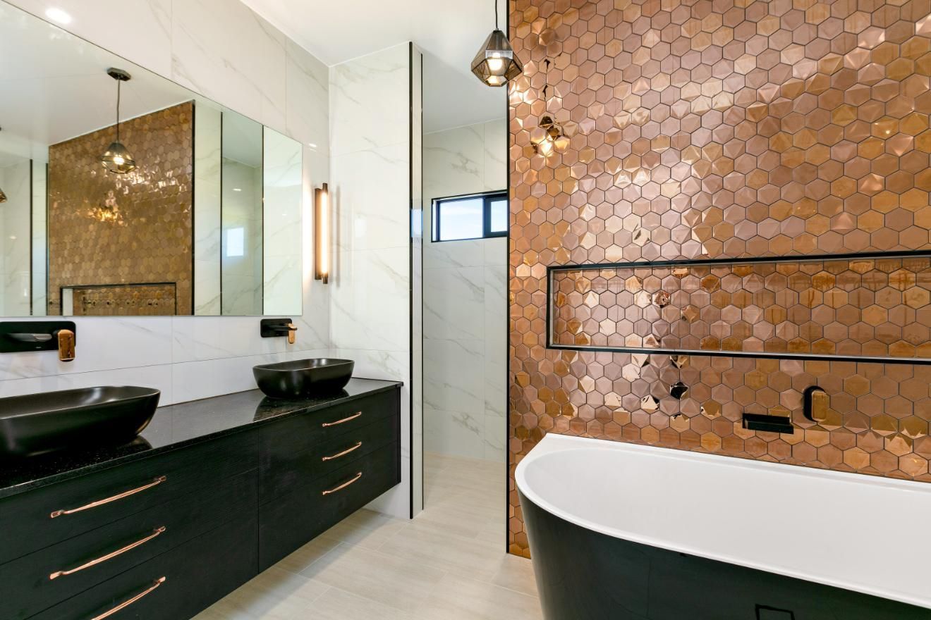A Bathroom With Two Sinks and a Bathtub — Ashlee Jones Homes in Gordonvale, QLD