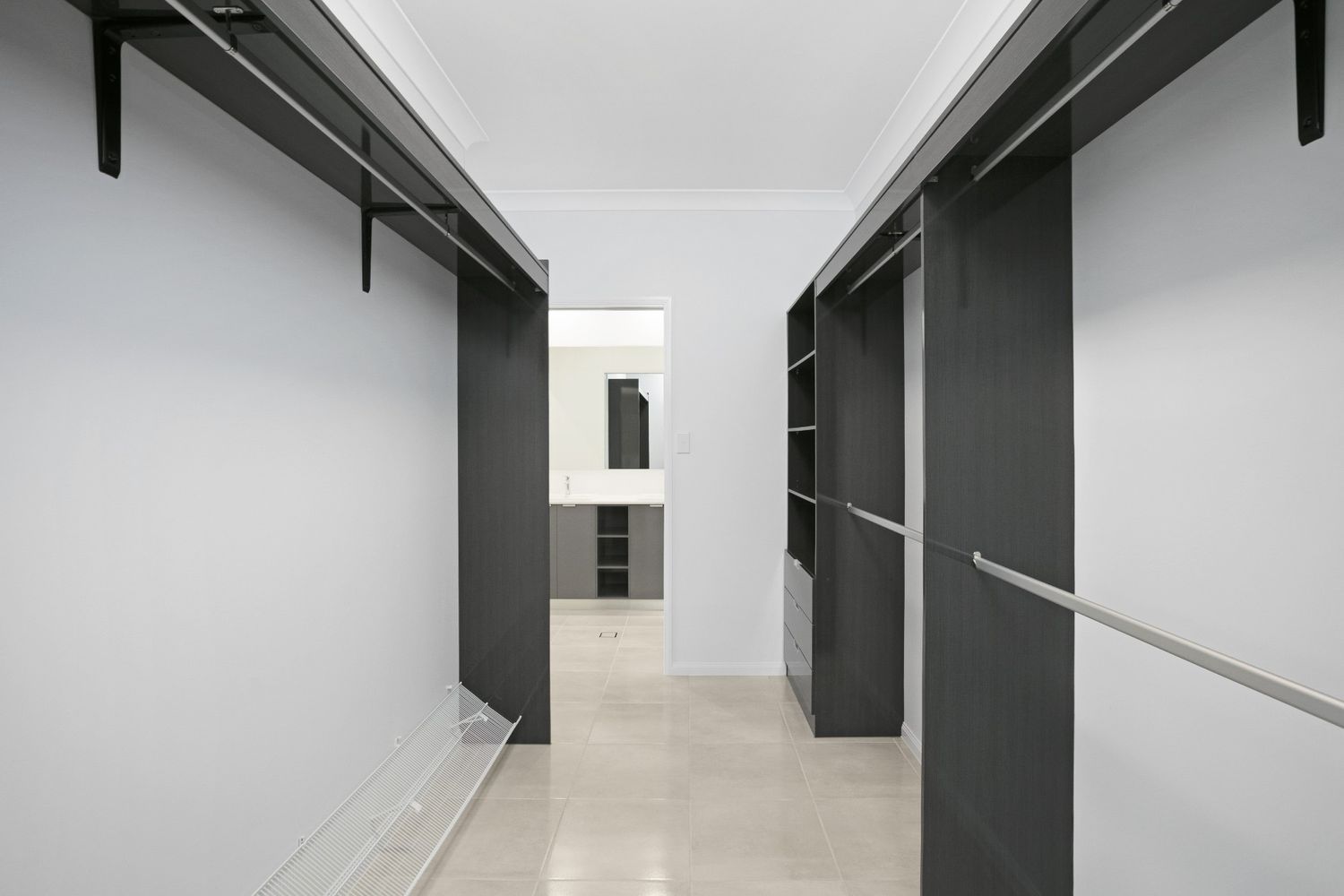 A Walk in Closet With a Lot of Shelves and Clothes Racks — Ashlee Jones Homes in Gordonvale, QLD