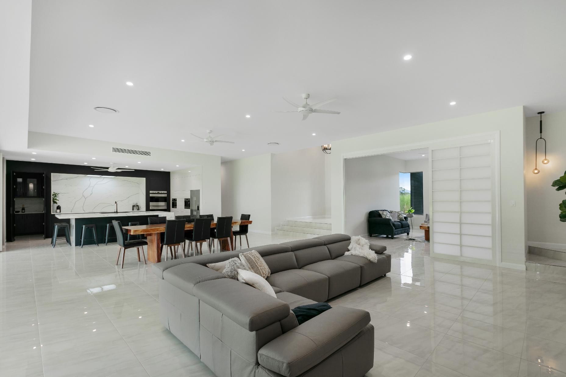 There is a Large Couch in the Middle of the Living Room — Ashlee Jones Homes in Gordonvale, QLD