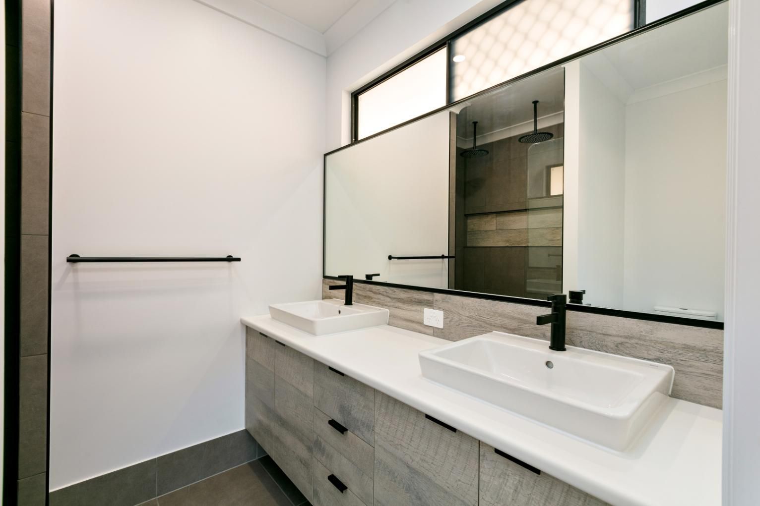 A Bathroom With Two Sinks and Two Mirrors — Ashlee Jones Homes in Gordonvale, QLD