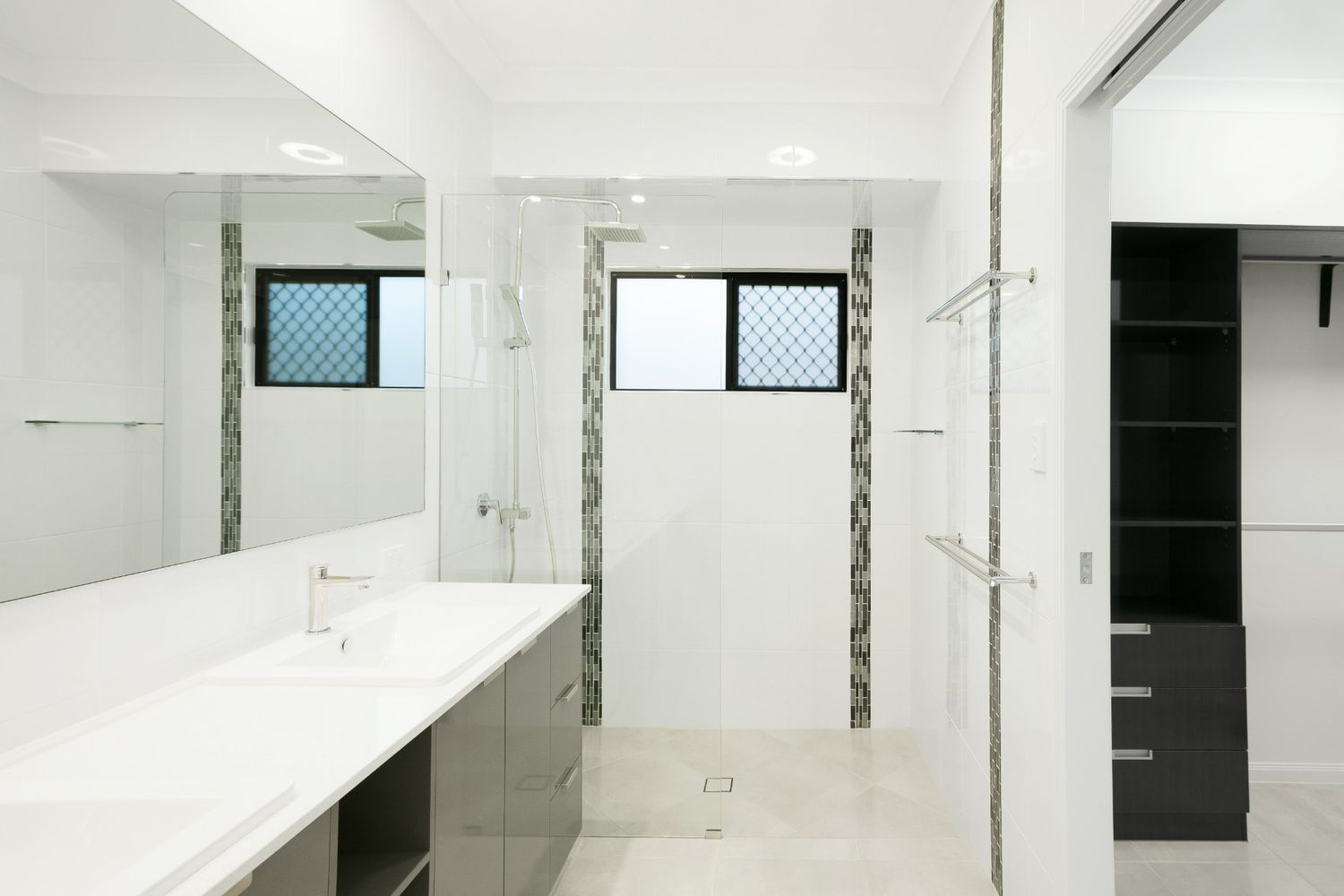 A Bathroom With Two Sinks, a Shower and a Window — Ashlee Jones Homes in Gordonvale, QLD