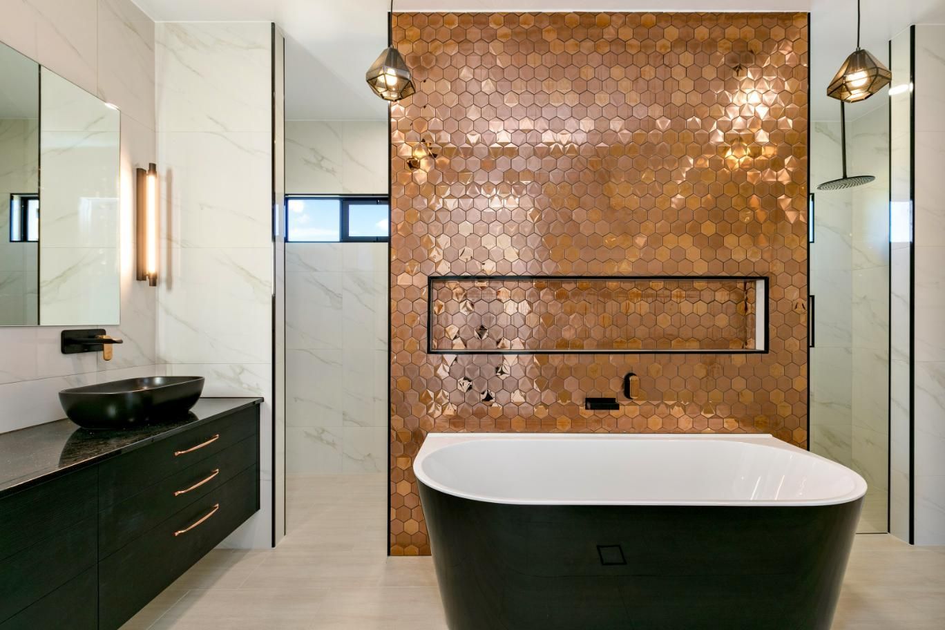 A Bathroom With a Bathtub, Sink and Mirror — Ashlee Jones Homes in Gordonvale, QLD