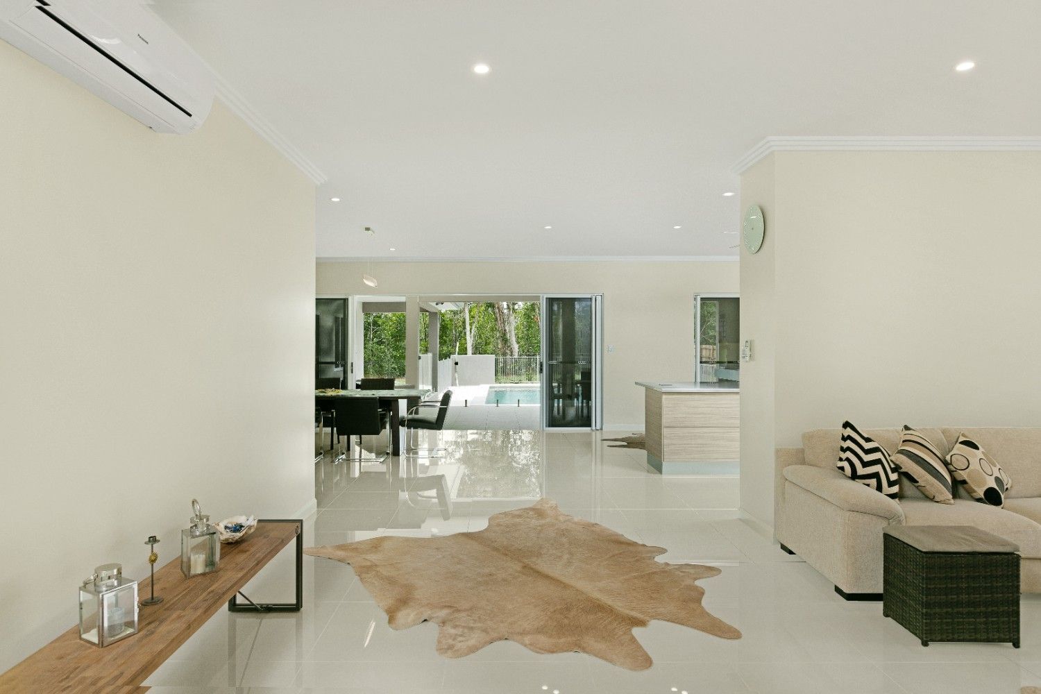 A Living Room With a Cowhide Rug on the Floor — Ashlee Jones Homes in Gordonvale, QLD
