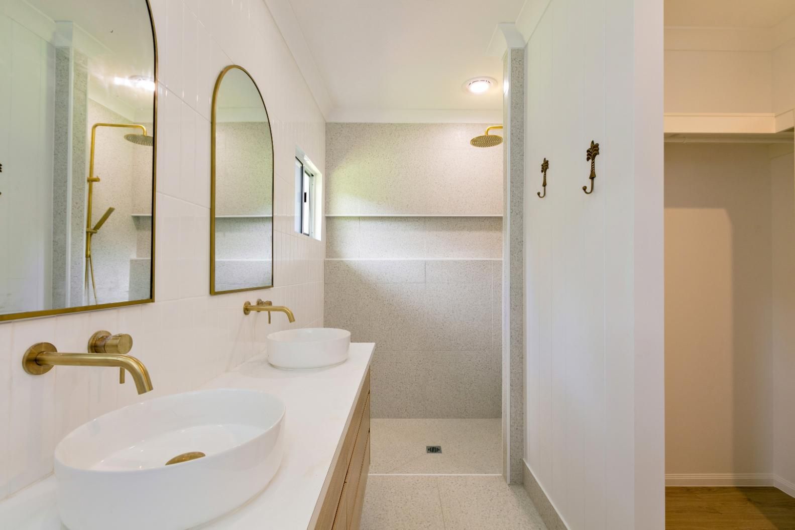 A Bathroom With Two Sinks and a Walk in Shower — Ashlee Jones Homes in Gordonvale, QLD