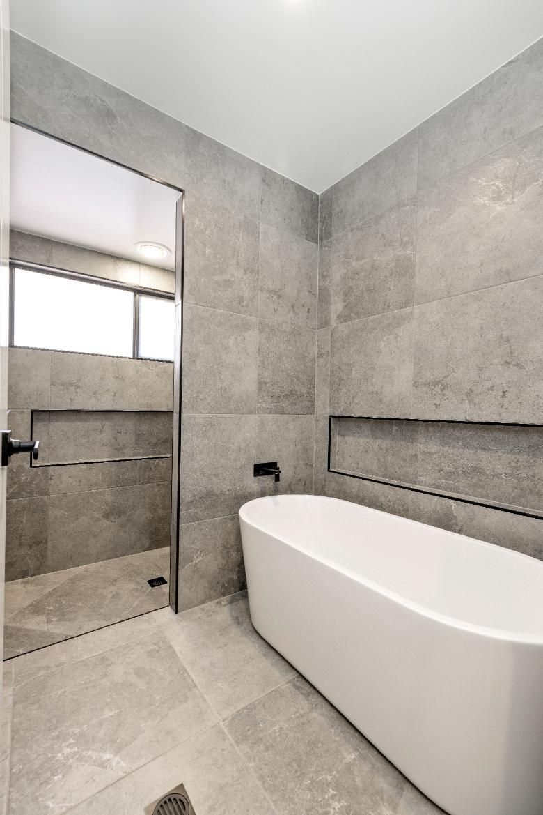 A Bathroom With a Bathtub and a Shower — Ashlee Jones Homes in Gordonvale, QLD