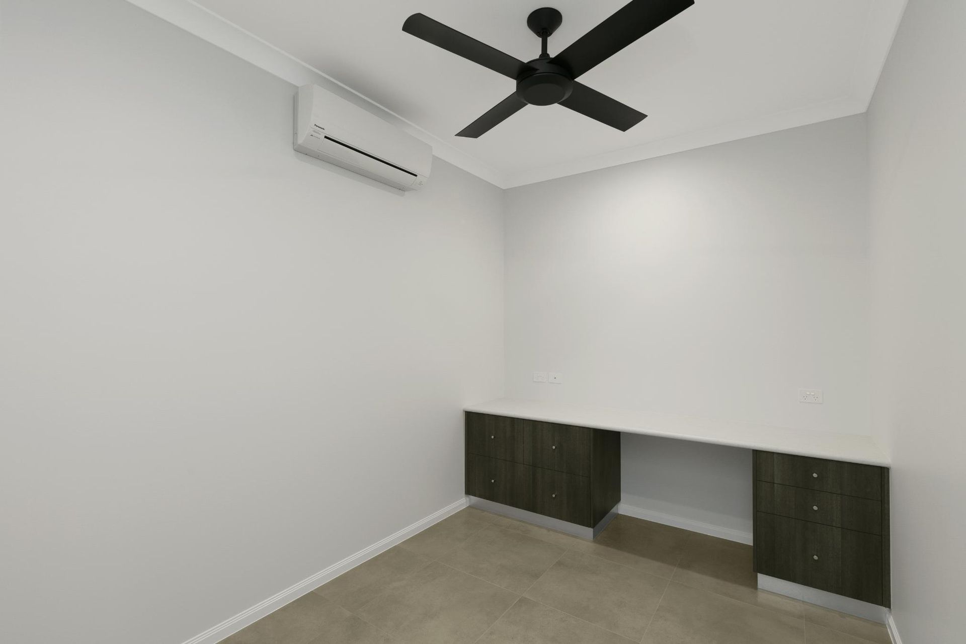 An Empty Room With a Ceiling Fan and Air Conditioner — Ashlee Jones Homes in Gordonvale, QLD