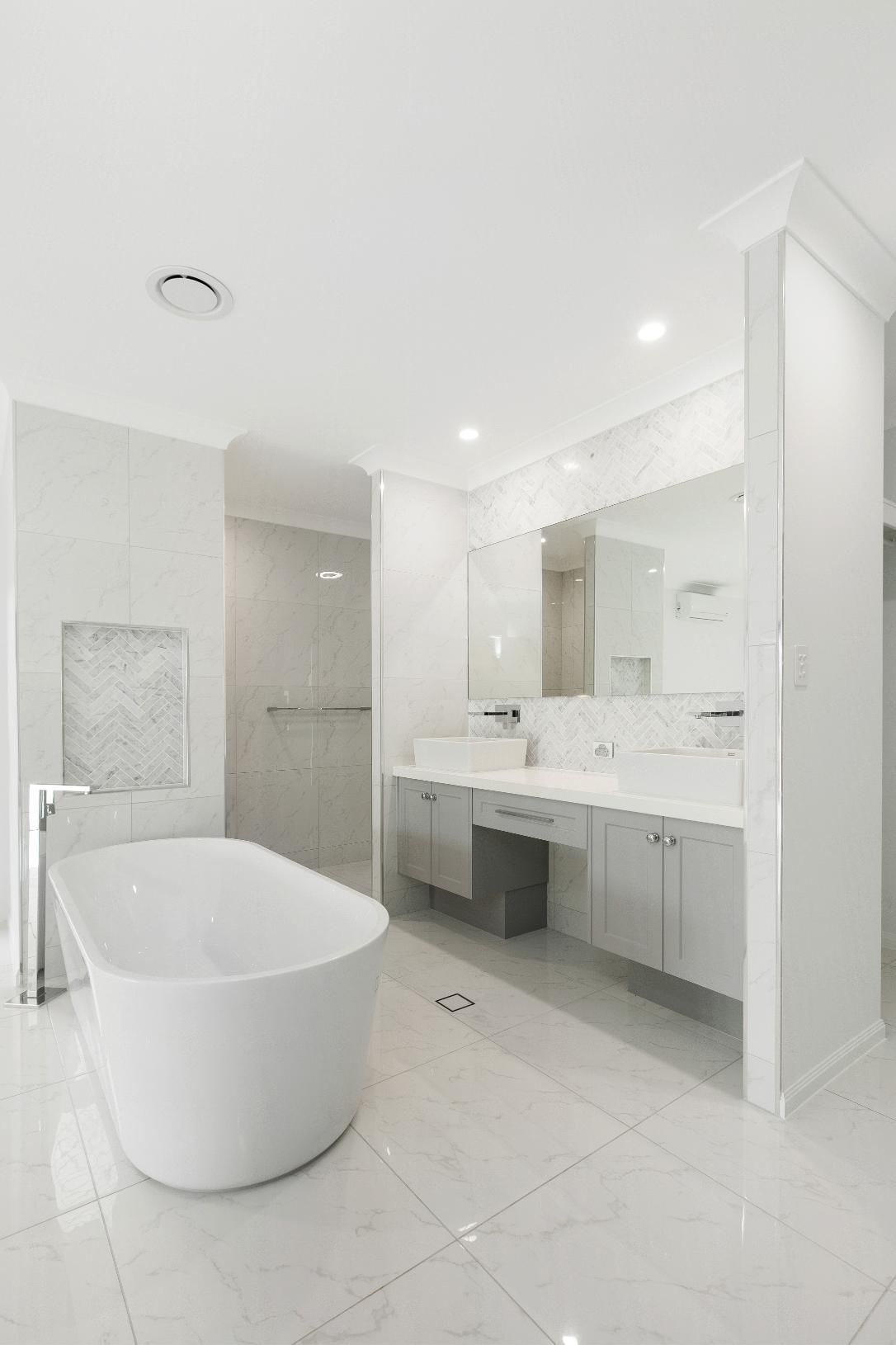 A Bathroom With a Bathtub, Sinks, Mirrors and a Walk in Shower — Ashlee Jones Homes in Gordonvale, QLD