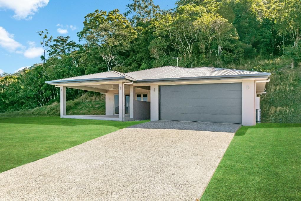 A House With a Garage and a Driveway in Front of It — Ashlee Jones Homes in Gordonvale, QLD