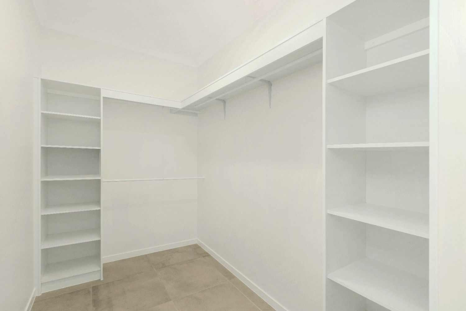 A Walk in Closet With Lots of Shelves and Clothes Racks — Ashlee Jones Homes in Gordonvale, QLD