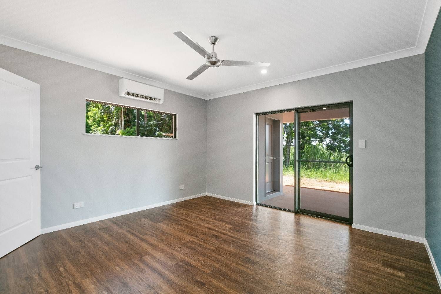 A Room With Hardwood Floors and a Ceiling Fan — Ashlee Jones Homes in Gordonvale, QLD
