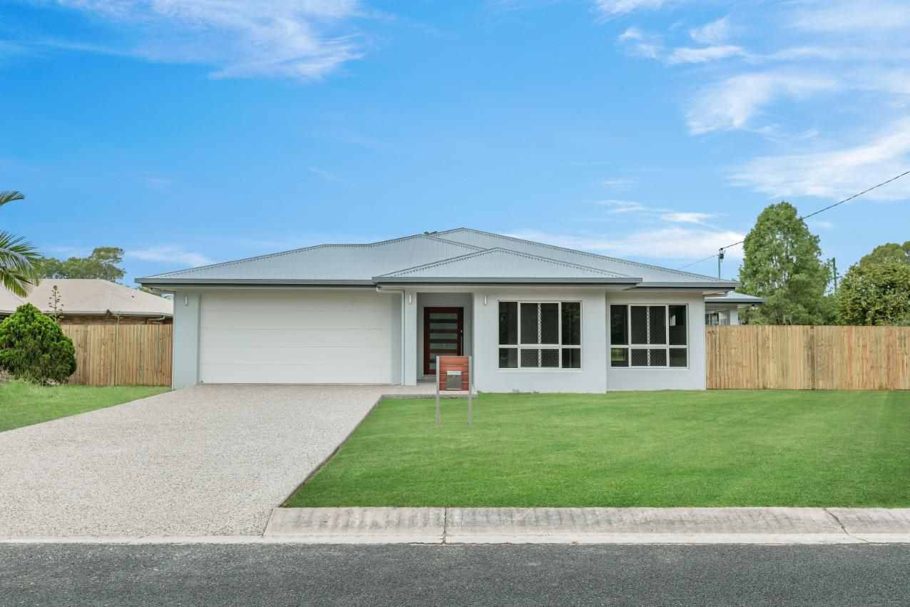 A White House With a Wooden Fence in Front of It is for Sale — Ashlee Jones Homes in Gordonvale, QLD