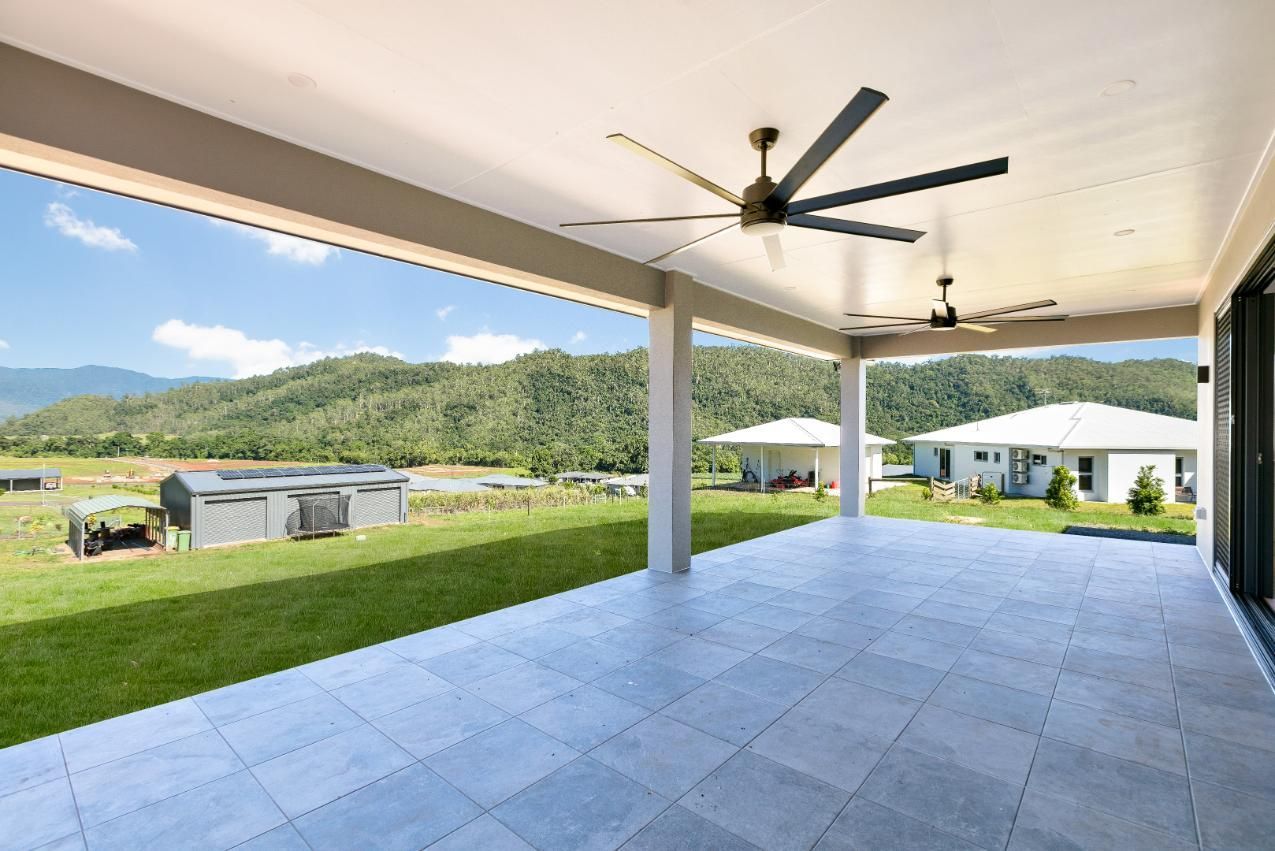 A Large Patio With a Ceiling Fan and Mountains in the Background — Ashlee Jones Homes in Gordonvale, QLD