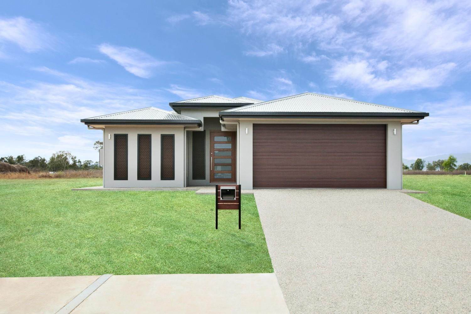 A House With a Brown Garage Door and a Mailbox in Front of It — Ashlee Jones Homes in Gordonvale, QLD