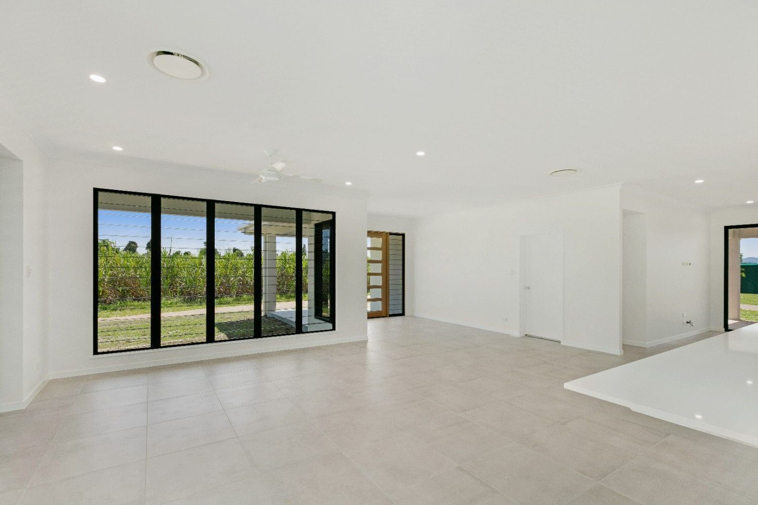 An Empty Living Room in a House With a Lot of Windows — Ashlee Jones Homes in Gordonvale, QLD
