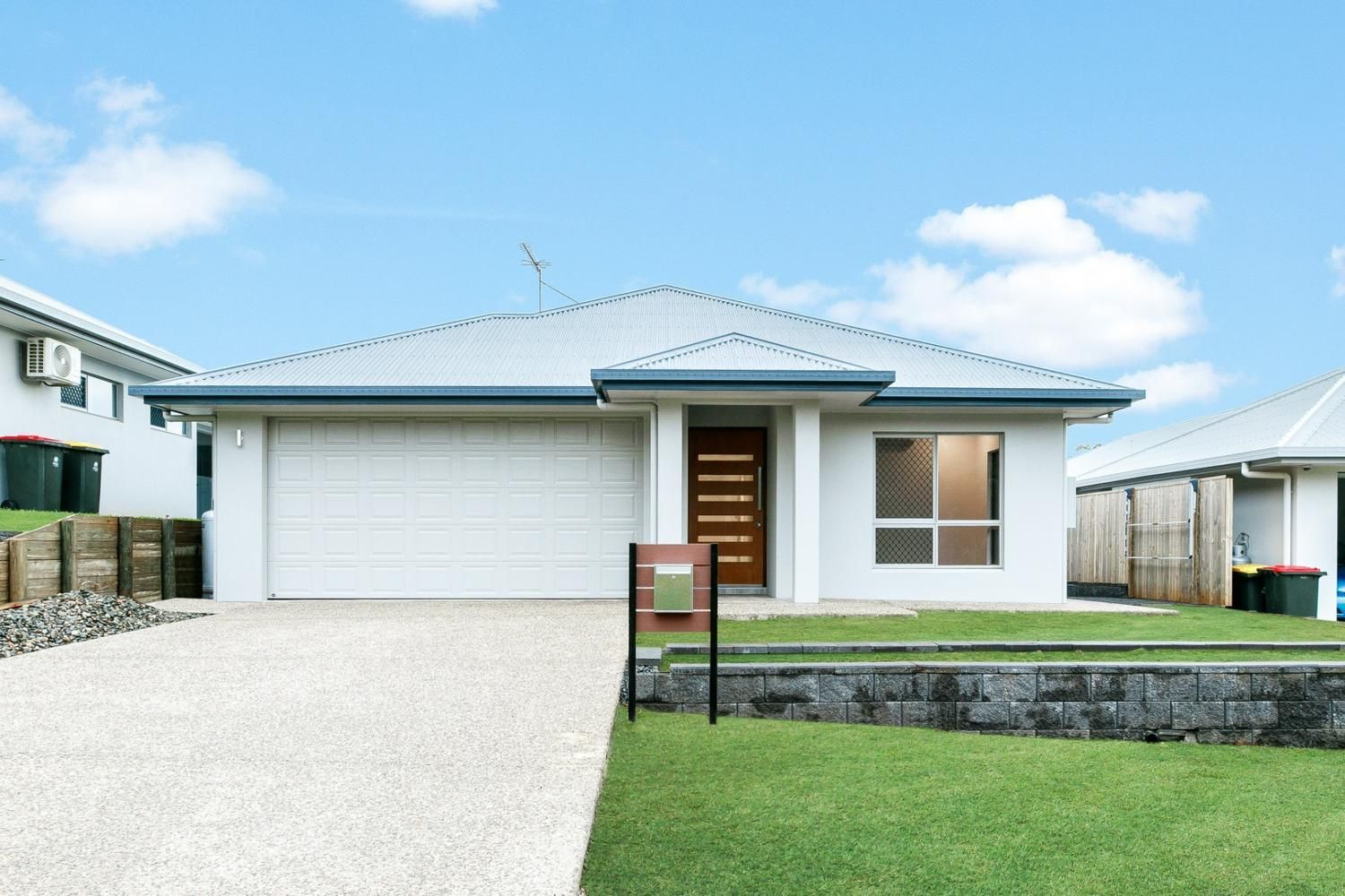 A White House With a Red Mailbox in Front of It — Ashlee Jones Homes in Gordonvale, QLD
