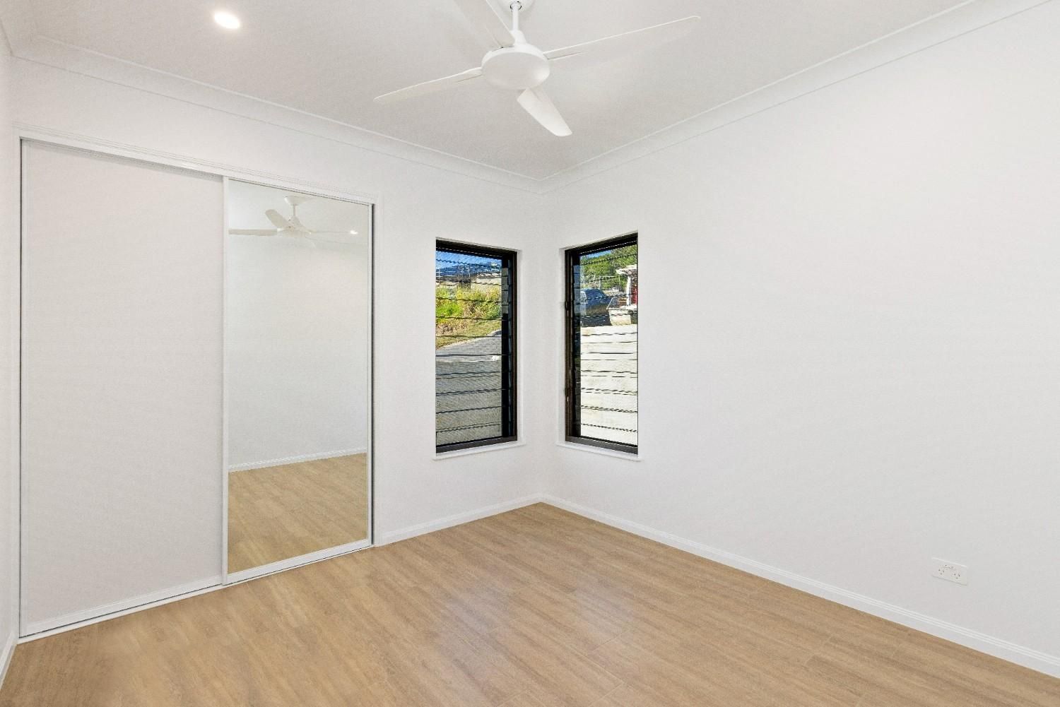 There is a Ceiling Fan in the Room and a Large Mirror on the Wall — Ashlee Jones Homes in Gordonvale, QLD