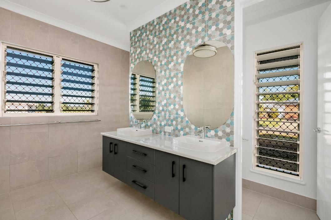 A Bathroom With Two Sinks, Two Mirrors and Two Windows — Ashlee Jones Homes in Gordonvale, QLD