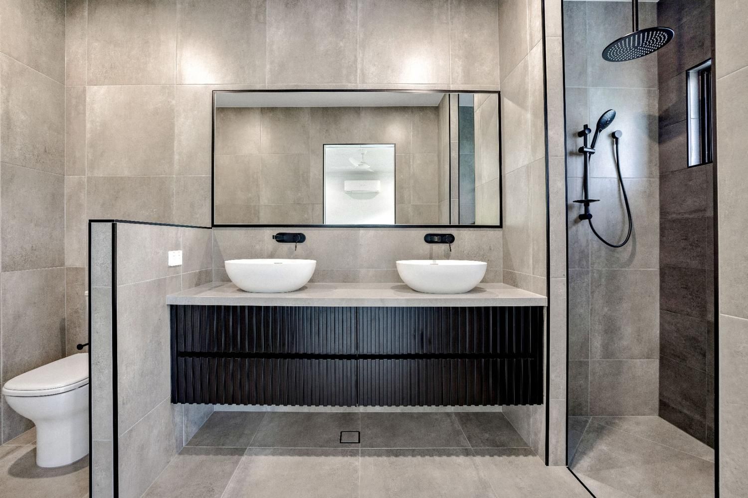 A Bathroom With Two Sinks, a Toilet and a Shower — Ashlee Jones Homes in Gordonvale, QLD