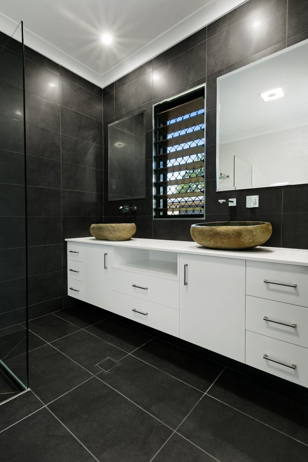 A Bathroom With Two Sinks and a Walk in Shower — Ashlee Jones Homes in Gordonvale, QLD