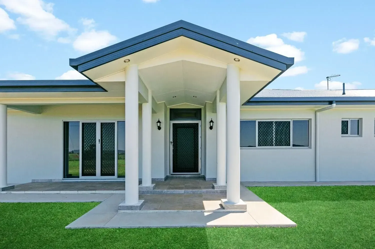 A Bathroom With Two Sinks, a Shower and a Window — Ashlee Jones Homes in Gordonvale, QLD