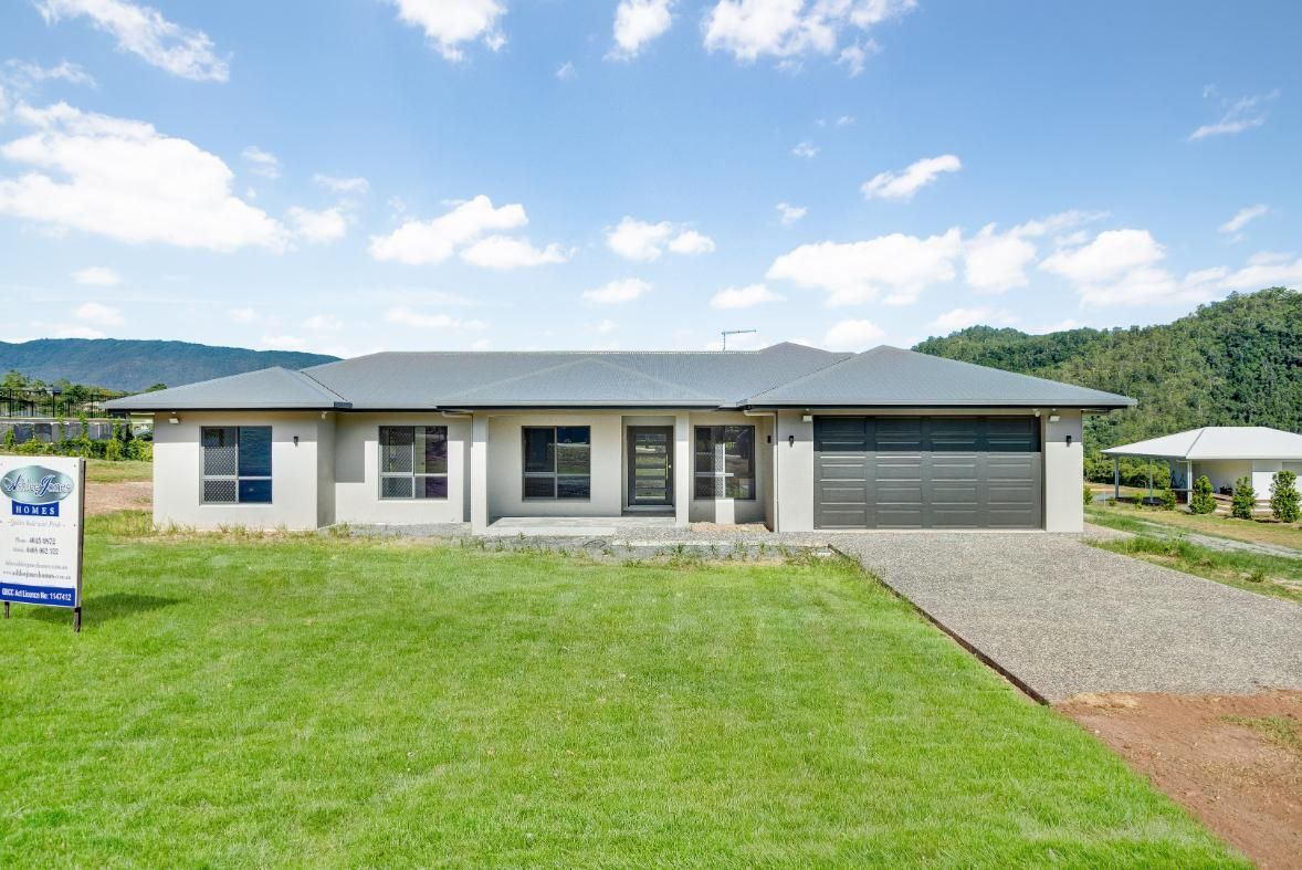 A House With a Garage and a Sign in Front of It — Ashlee Jones Homes in Gordonvale, QLD