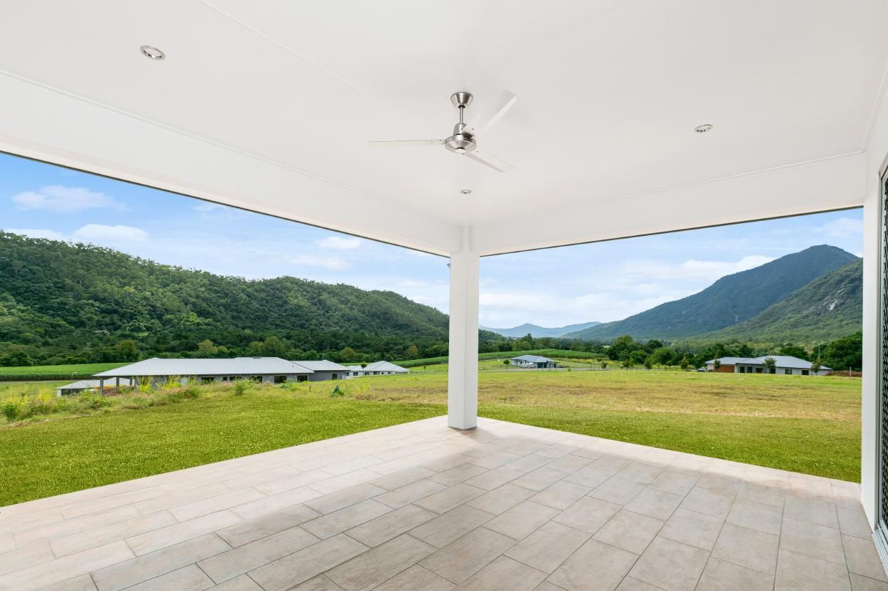 An Empty Patio With a View of a Field and Mountains — Ashlee Jones Homes in Gordonvale, QLD