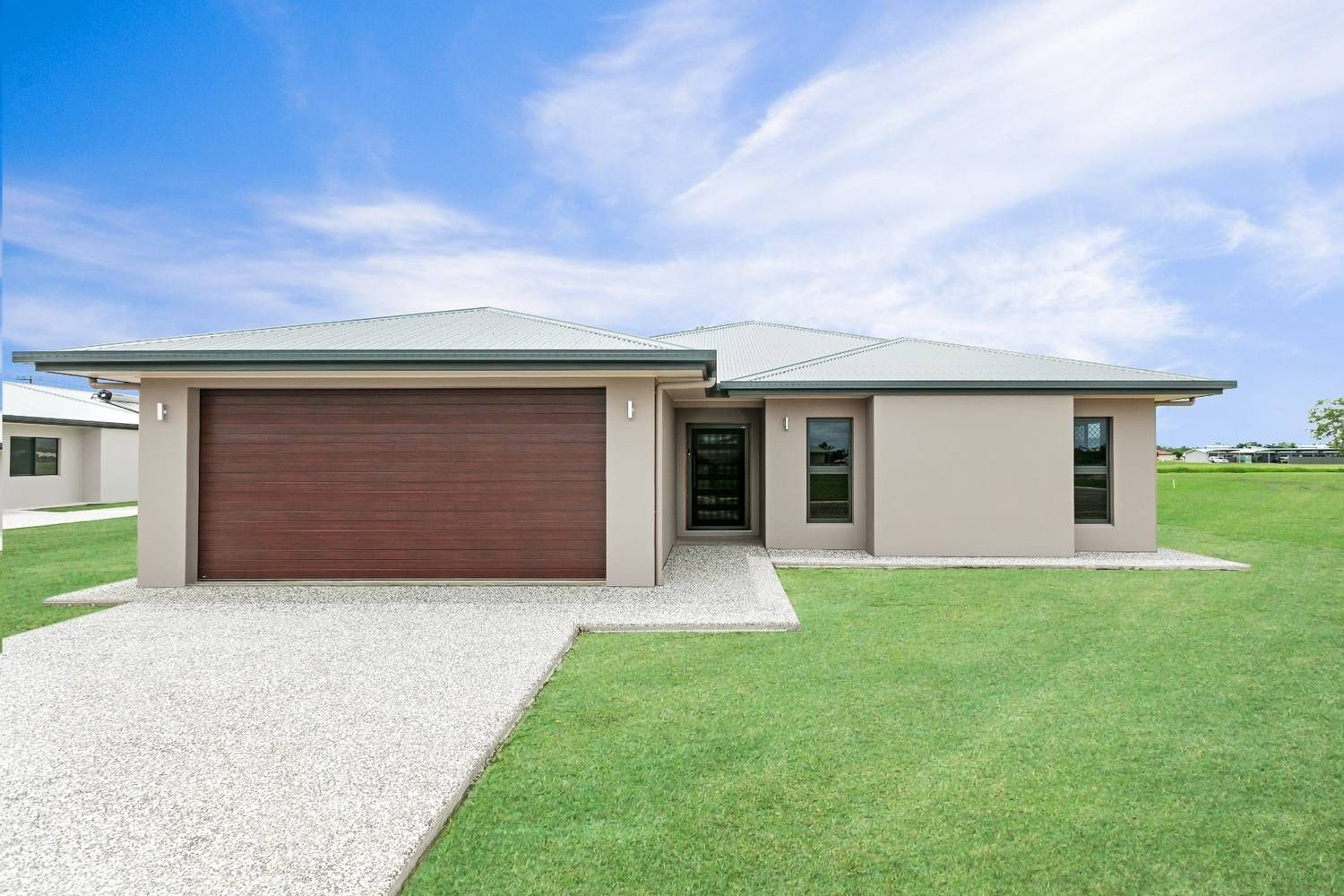 A House With a Garage and a Driveway in Front of It — Ashlee Jones Homes in Gordonvale, QLD