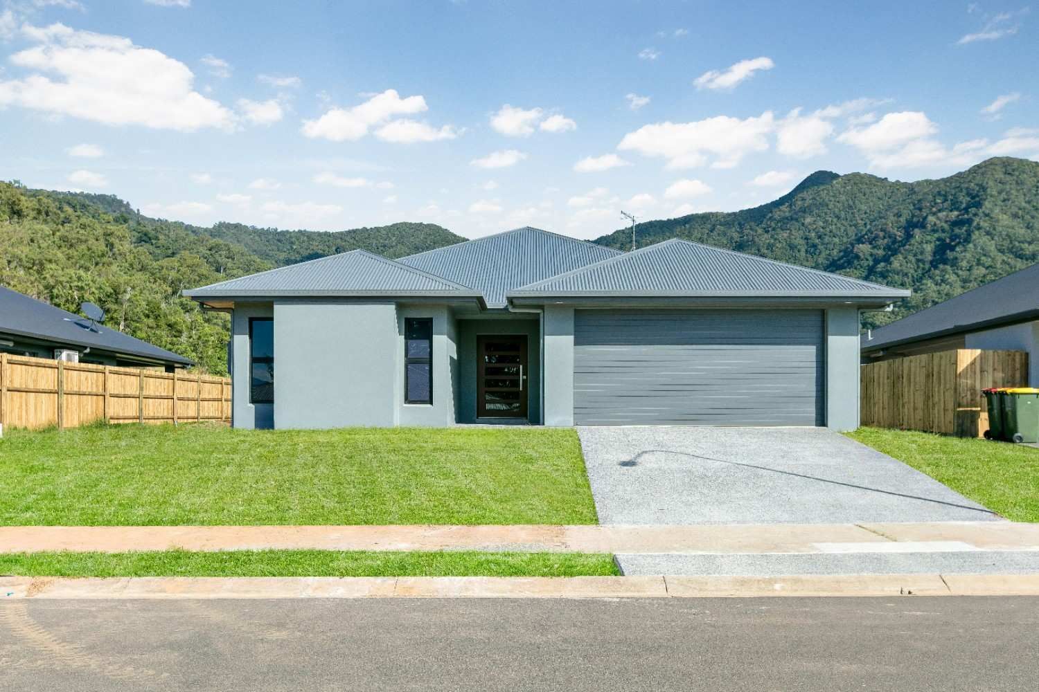 A Gray House With a Garage and Mountains in the Background — Ashlee Jones Homes in Gordonvale, QLD