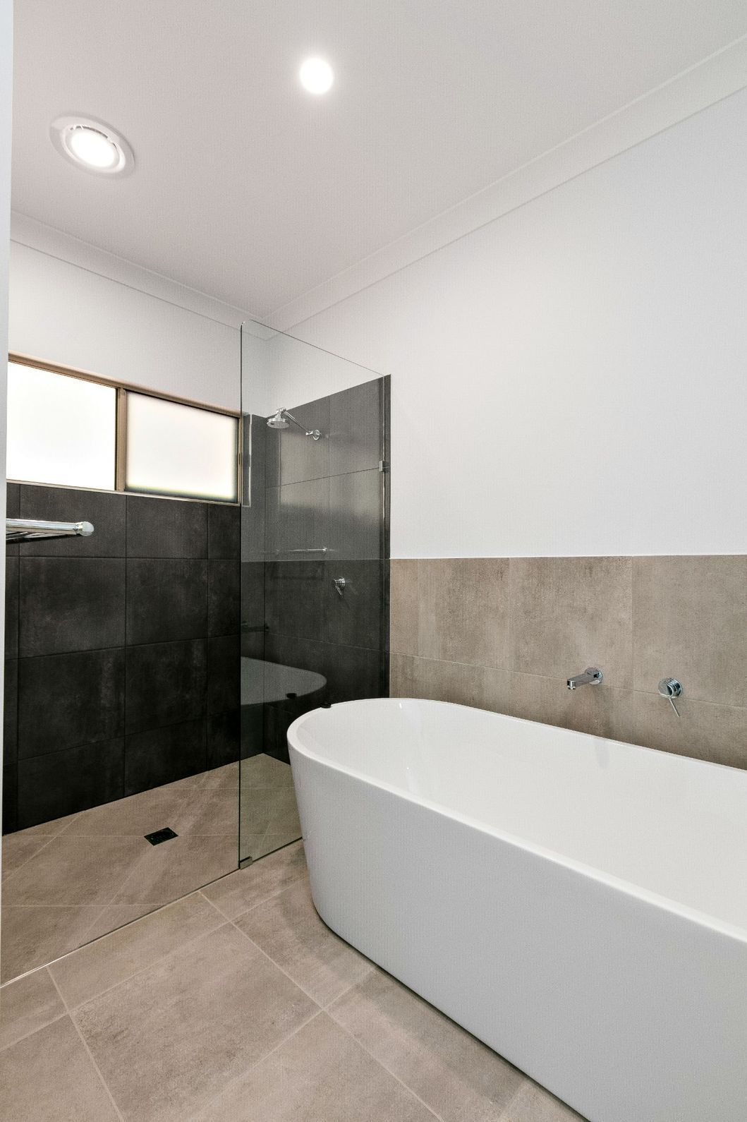 A Bathroom With a Bathtub and a Walk in Shower — Ashlee Jones Homes in Gordonvale, QLD