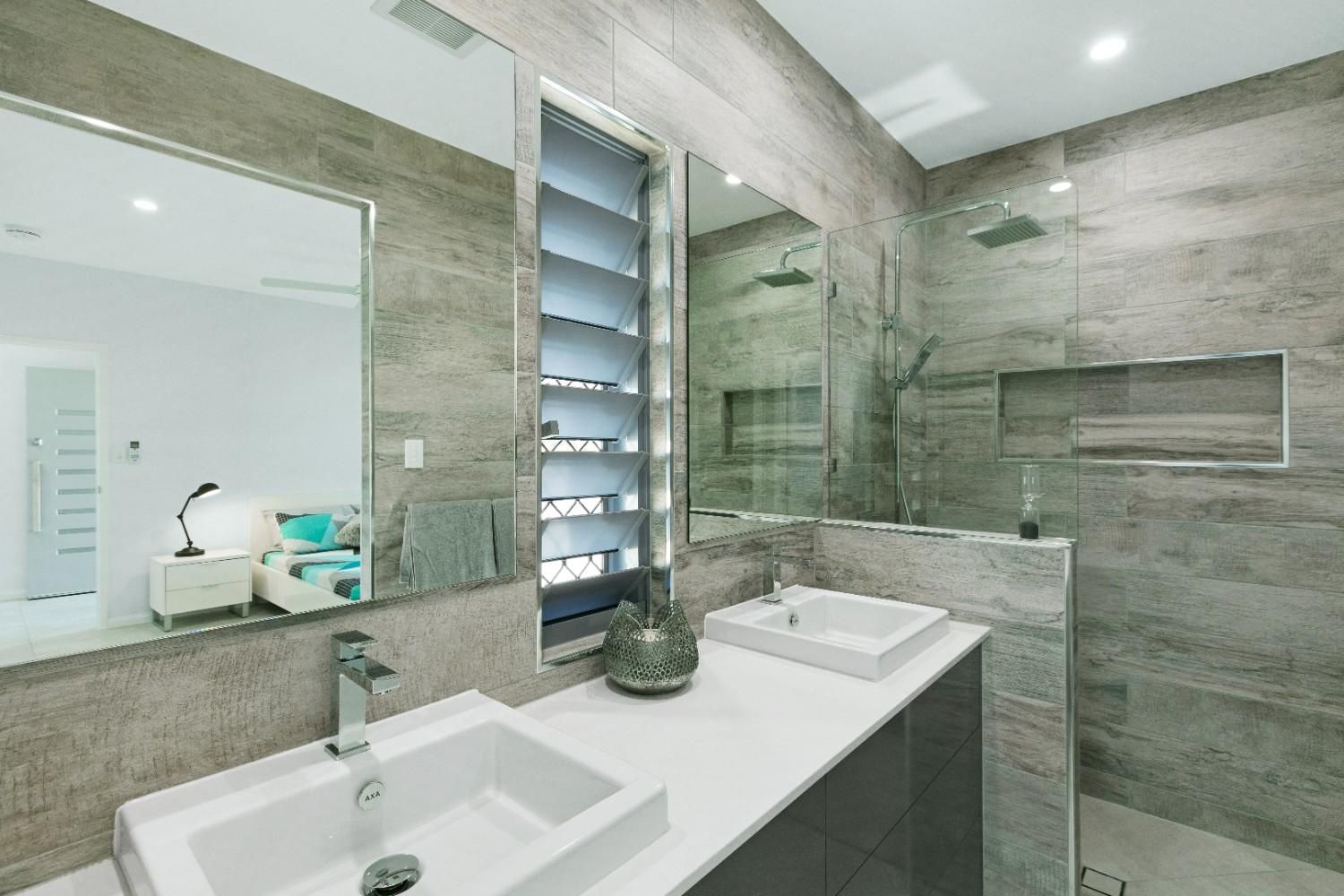 A Bathroom With Two Sinks and a Large Mirror — Ashlee Jones Homes in Gordonvale, QLD