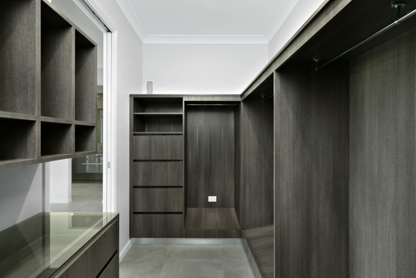 A Walk in Closet With Lots of Shelves and Drawers — Ashlee Jones Homes in Gordonvale, QLD