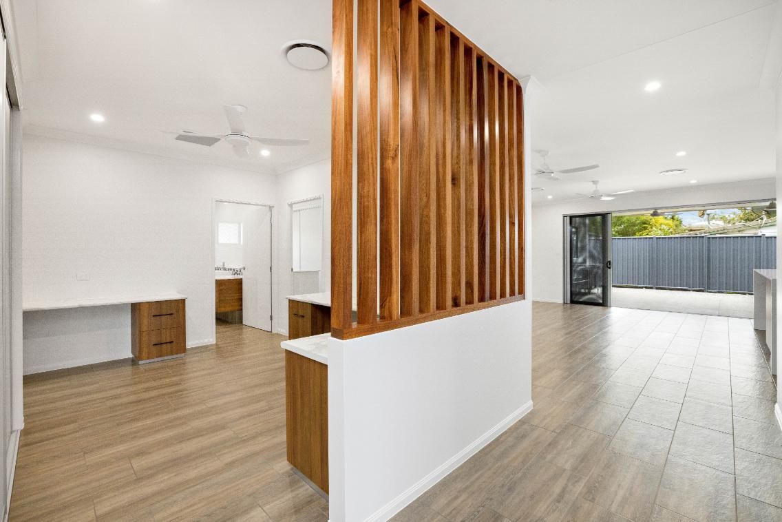 There is a Wooden Divider Between the Living Room and the Kitchen — Ashlee Jones Homes in Gordonvale, QLD