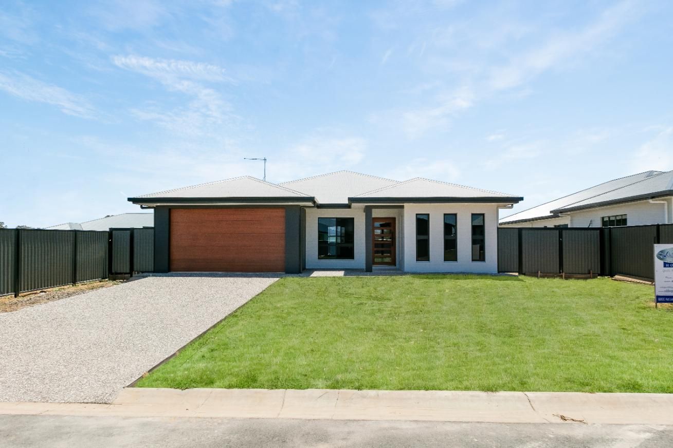 A House With a Large Lawn in Front of It is for Sale — Ashlee Jones Homes in Gordonvale, QLD