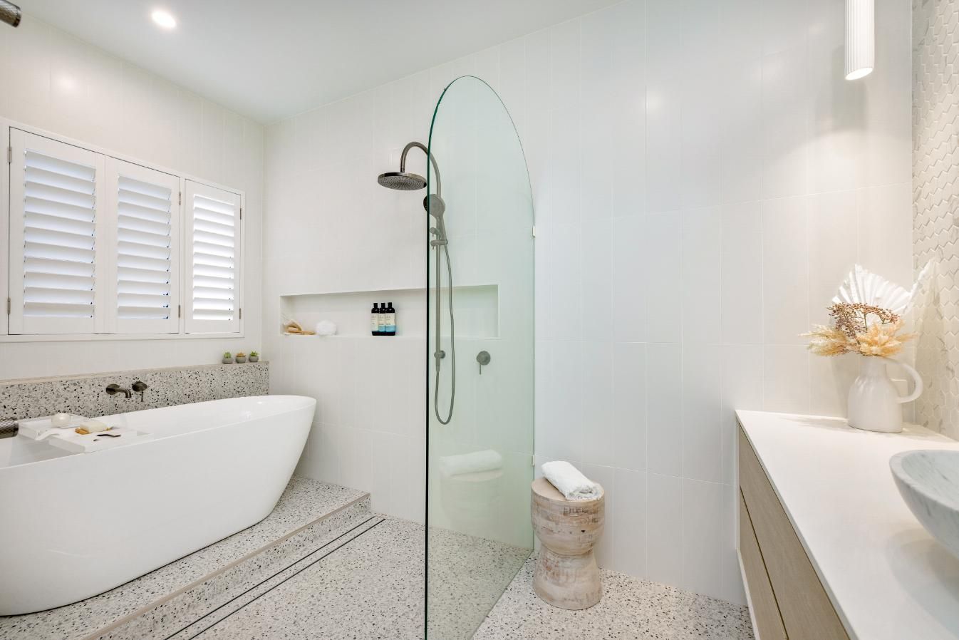 A Bathroom With a Bathtub and a Walk in Shower — Ashlee Jones Homes in Gordonvale, QLD