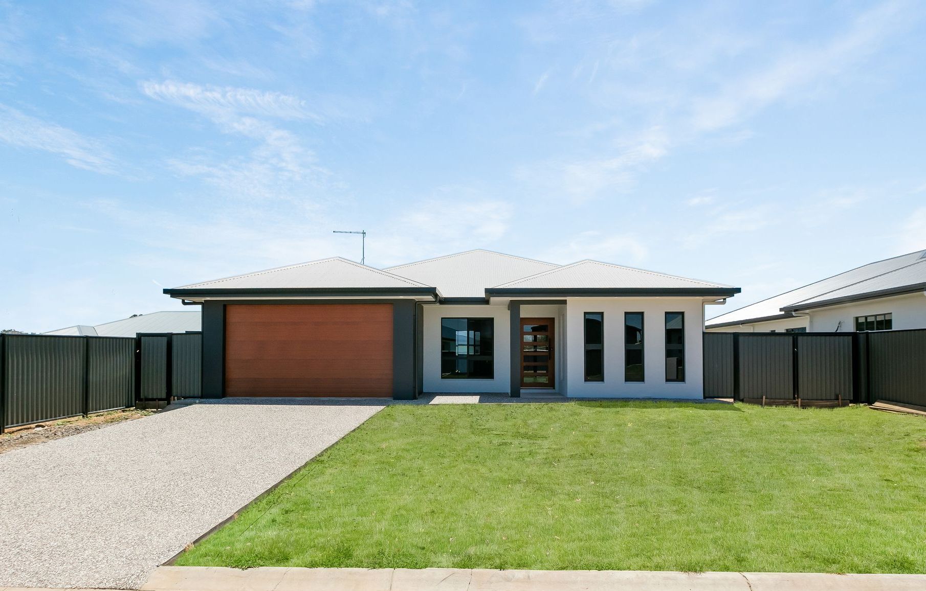 A Bedroom With a Bed, Couch, and Bathroom — Ashlee Jones Homes in Gordonvale, QLD