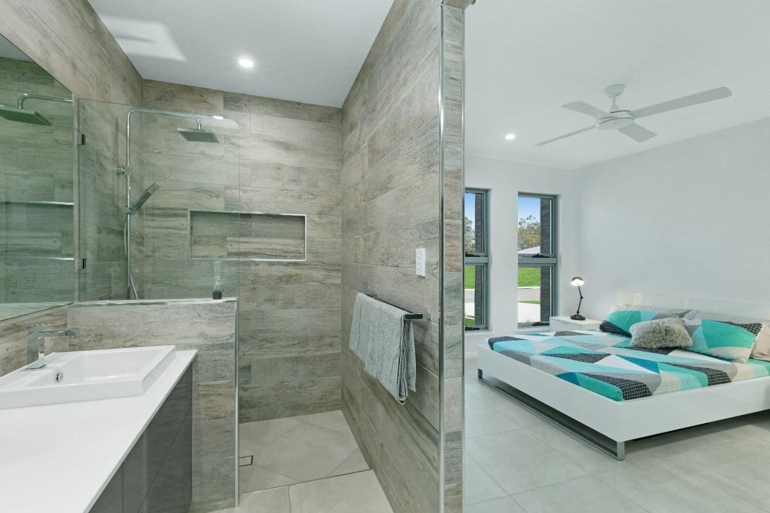 A Bathroom With a Walk in Shower and a Sink Next to a Bedroom — Ashlee Jones Homes in Gordonvale, QLD
