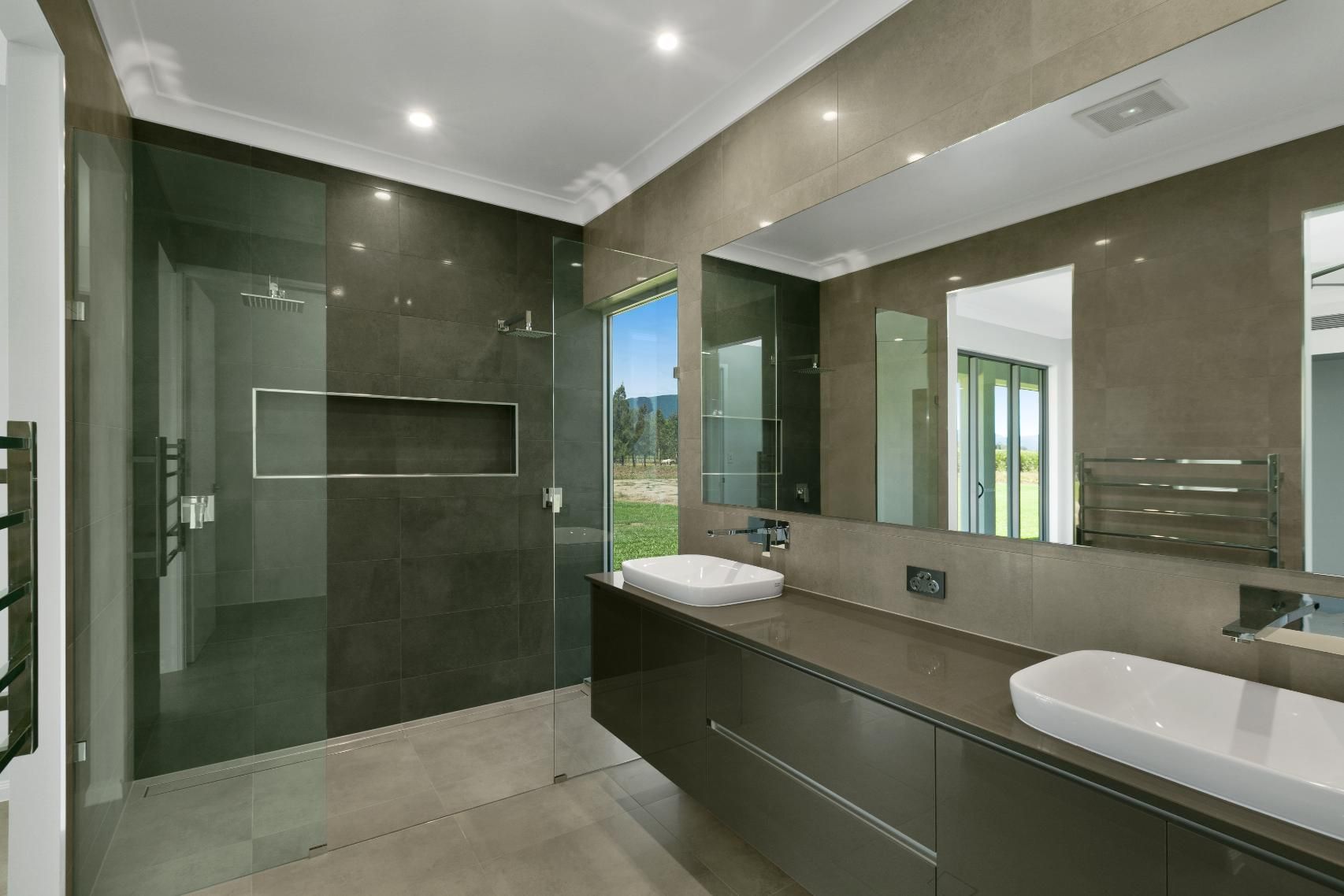 A Bathroom With Two Sinks and a Walk in Shower — Ashlee Jones Homes in Gordonvale, QLD